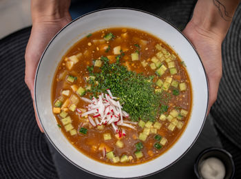 Midsection of person holding soup in bowl