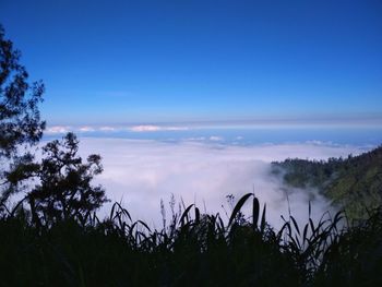 Scenic view of land against blue sky