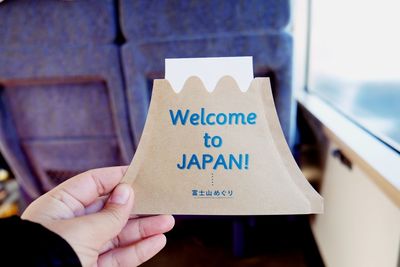 Person holding welcome card on journey