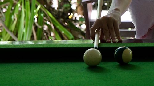 Close-up of man playing with ball on table