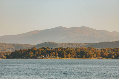 Scenic view of sea and mountains against sky