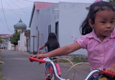 Girl riding bicycle in city