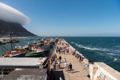 People on beach against sky