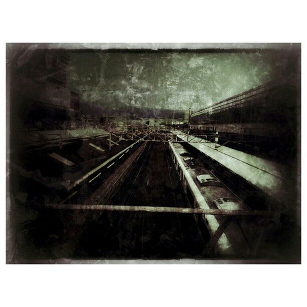 transfer print, auto post production filter, railroad track, transportation, rail transportation, architecture, built structure, indoors, building exterior, abandoned, public transportation, day, diminishing perspective, no people, the way forward, train - vehicle, railway track, sky, damaged