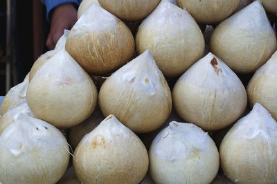 Stacked fresh peeled coconuts ready to drink