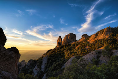 Low angle view of rock formations against sky during sunset