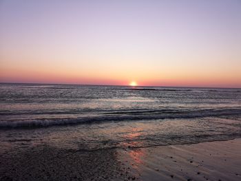 Scenic view of sea against romantic sky at sunset