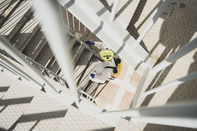 Firefighter disinfecting walls and floors inside a building