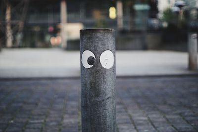 Close-up of electric lamp on street in city