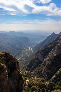 Scenic view of valley and mountains against sky