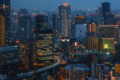 High angle view of illuminated buildings in city against sky