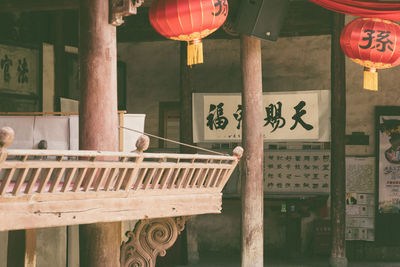 Illuminated lanterns hanging by building