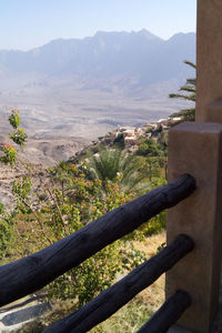 Close-up of railing against mountains