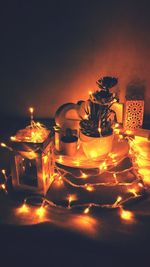 Close-up of illuminated tea light candles on table