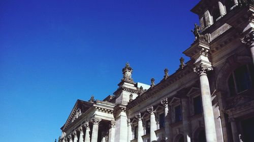 Low angle view of building against clear blue sky