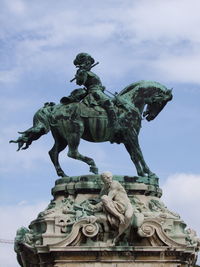 Low angle view of statue against sky