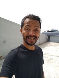 Portrait of smiling young man standing outdoors