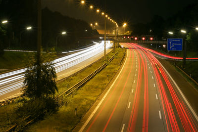 High angle view of light trails on highway at night