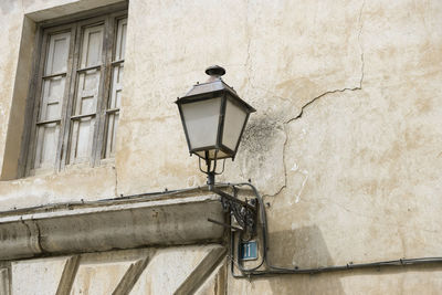 Low angle view of street light against building