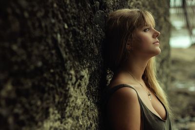 Side view of young woman standing outdoors