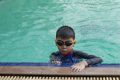 Boy swimming in pool