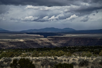 Scenic view of landscape against cloudy sky