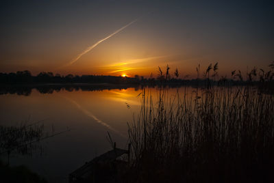 Scenic view of lake against romantic sky at sunset