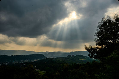 Low angle view of storm clouds over mountains