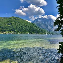 Scenic view of sea and mountains against sky