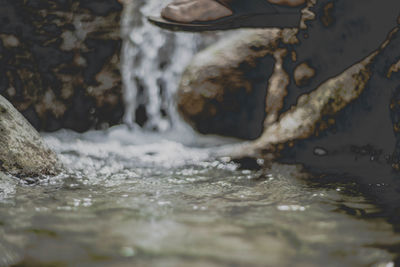 Close-up of water flowing through rocks
