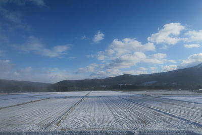 Scenic view of landscape against sky during winter