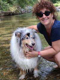 Portrait of woman with dog in water