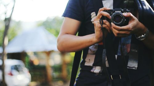 Midsection of woman photographing