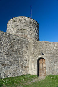 Low angle view of historic building against blue sky