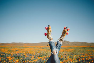 Full length of person standing on field against clear sky