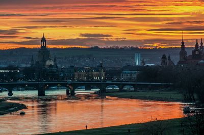 Cityscape with elbe river against orange sky during sunset