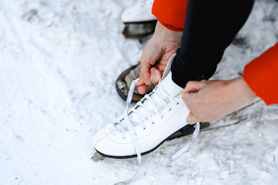 Low section of man skiing on snow