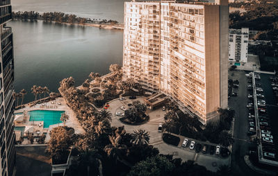 High angle view of buildings by lake in city