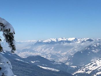 Scenic view of snow covered mountains against clear sky