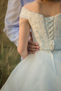 Midsection of couple during wedding ceremony