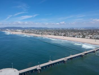 High angle view of bridge over sea against blue sky