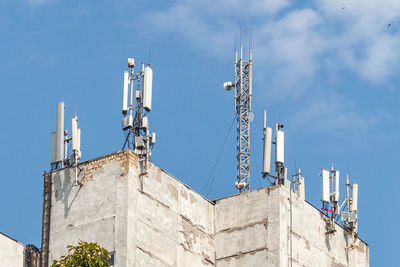 Telecommunication tower with 5g cellular network antenna on city background