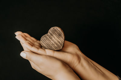 Close-up of person hand against black background