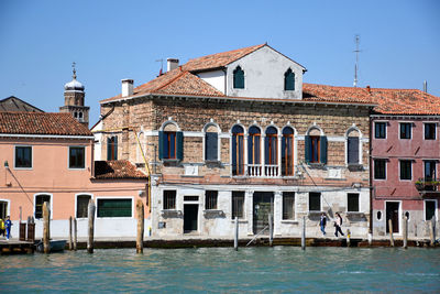 View of buildings against blue sky in the bay of murano