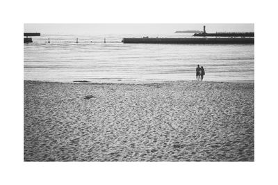 Rear view of man standing on beach