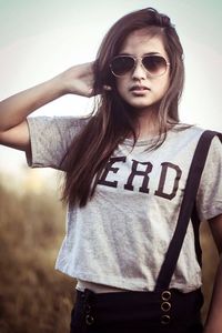 Portrait of a beautiful young woman wearing sunglasses