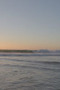 Scenic view of sea against clear sky during sunset