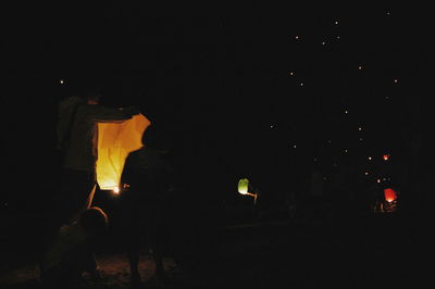 Silhouette of people at night