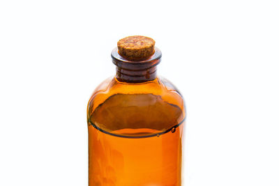 Close-up of glass bottle against white background