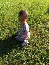 High angle view of cute baby girl on field